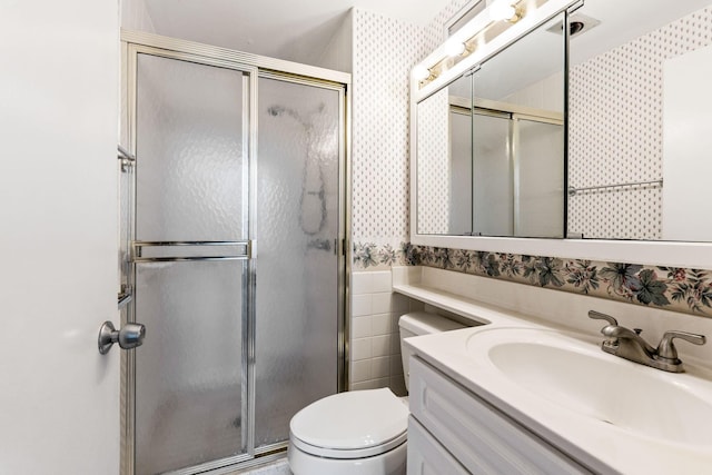 1000 Urlin Ave Unit 520, Columbus, OH 43212 - bathroom with wallpapered walls, vanity, a stall shower, a wainscoted wall, and tile walls