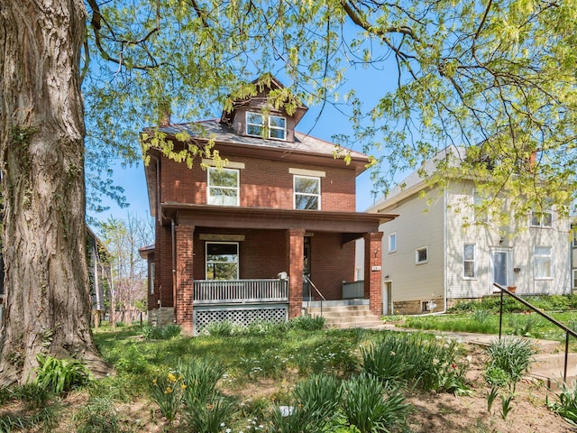 384 E 13th Ave, Columbus, OH 43201 - american foursquare style home with brick siding, a porch, and a chimney