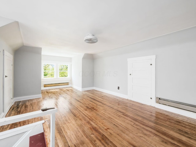 384 E 13th Ave, Columbus, OH 43201 - additional living space featuring a baseboard heating unit, light wood-style floors, and baseboards