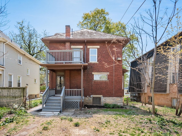 384 E 13th Ave, Columbus, OH 43201 - back of house with a chimney, brick siding, fence, and a balcony