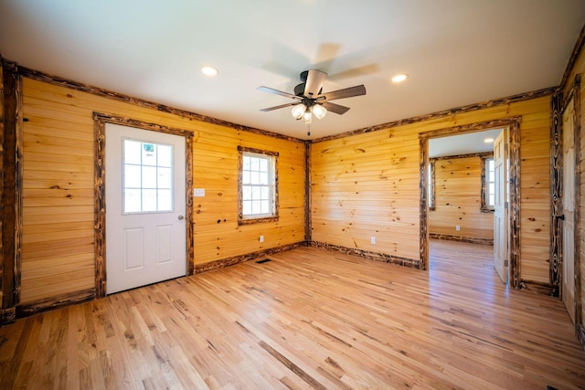 interior space featuring ceiling fan, wood walls, light wood-type flooring, baseboards, and recessed lighting