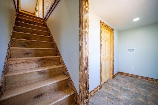 stairway featuring recessed lighting, baseboards, and stone finish flooring