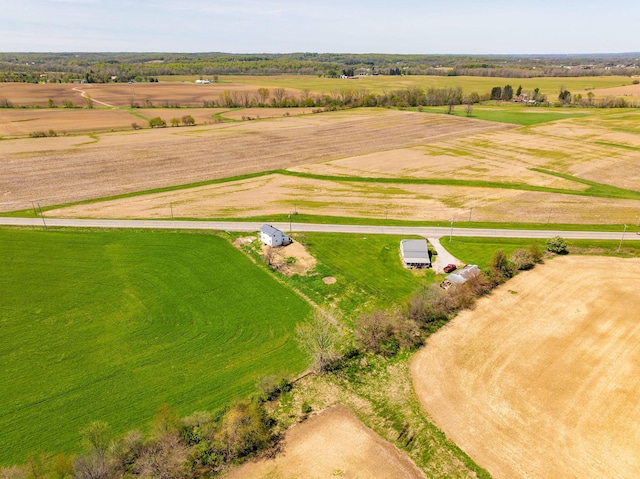birds eye view of property with a rural view