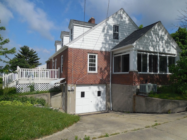 4228 State Route 229, Marengo, OH 43334 - back of house featuring brick siding, a chimney, an attached garage, driveway, and a wooden deck