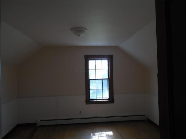 4228 State Route 229, Marengo, OH 43334 - additional living space featuring a baseboard heating unit, vaulted ceiling, wood finished floors, and wainscoting