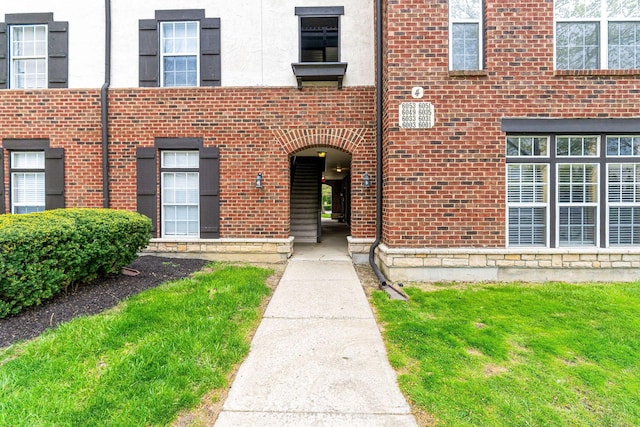 exterior space with a yard and brick siding
