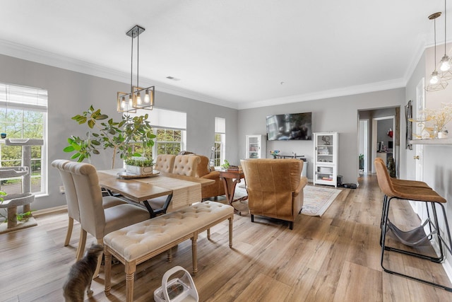 dining room with light wood finished floors, a chandelier, and a wealth of natural light