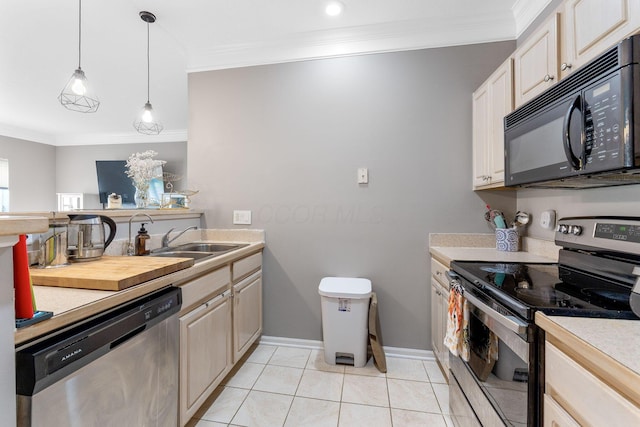 kitchen with a sink, light countertops, ornamental molding, and stainless steel appliances