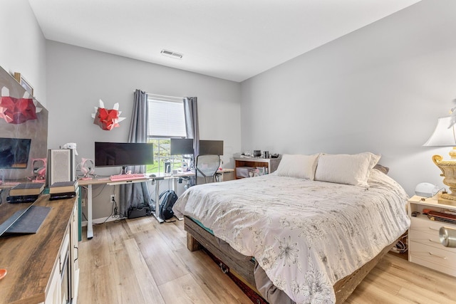 bedroom featuring visible vents and light wood-style floors