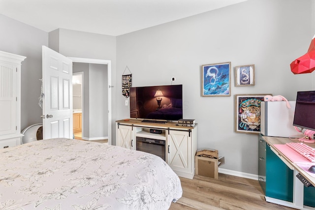 bedroom featuring baseboards and light wood-style flooring