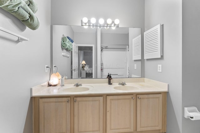 full bathroom featuring double vanity and a sink