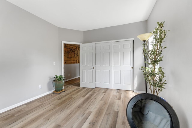 interior space featuring baseboards and light wood-style flooring