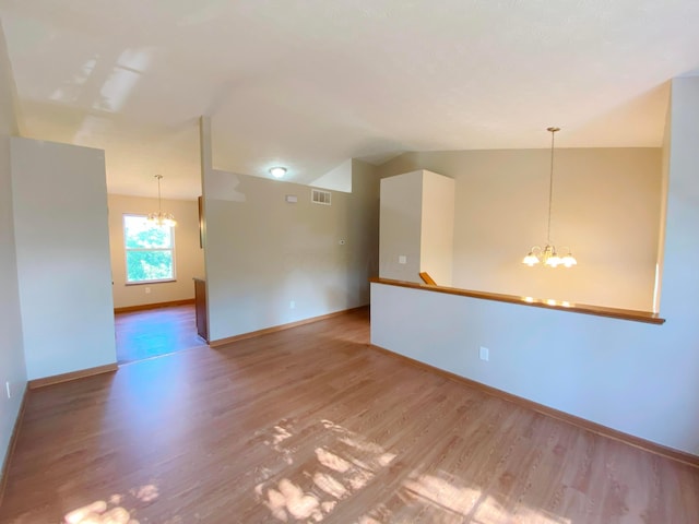 829 Crevis Ln, Columbus, OH 43228 - empty room with a chandelier, light wood-type flooring, and vaulted ceiling