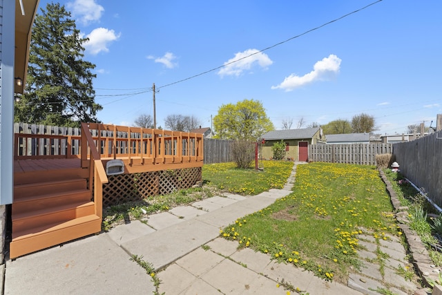 view of yard with a wooden deck and a fenced backyard