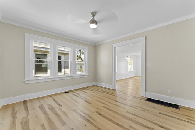 spare room with plenty of natural light, a ceiling fan, and ornamental molding