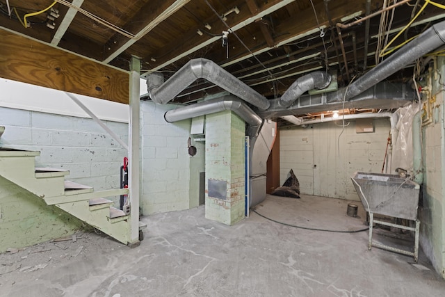 unfinished below grade area featuring stairs and a sink