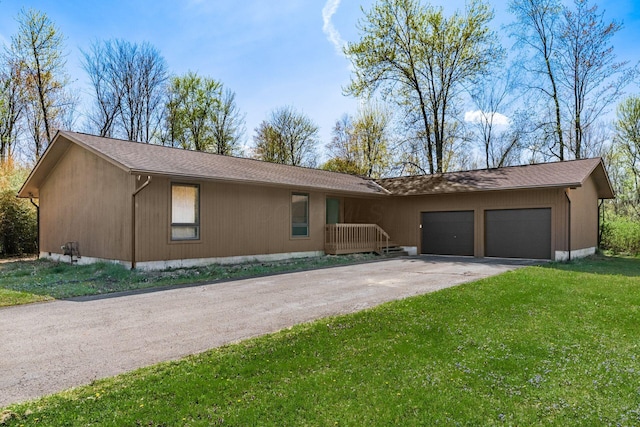 ranch-style house with aphalt driveway, a front lawn, and a garage