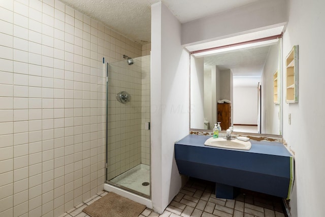 full bathroom with a shower stall and vanity
