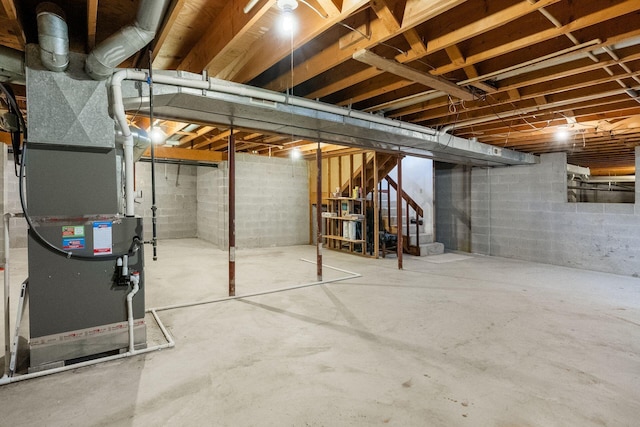 unfinished basement with heating unit and stairs