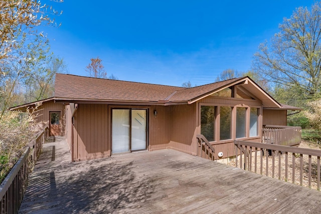 back of property featuring a wooden deck and a shingled roof