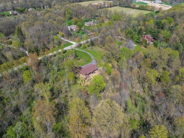 bird's eye view featuring a wooded view