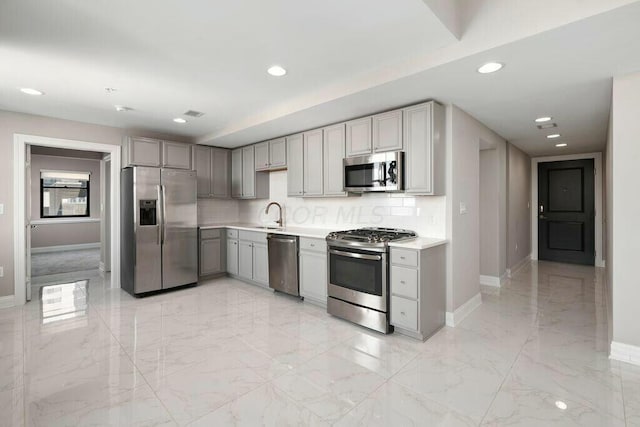 50 W Broad St Unit 2104, Columbus, OH 43215 - kitchen with baseboards, gray cabinetry, stainless steel appliances, and recessed lighting