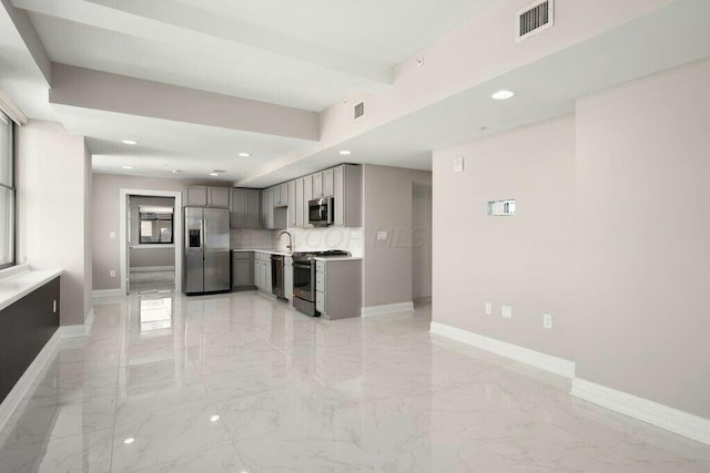 50 W Broad St Unit 2104, Columbus, OH 43215 - kitchen with gray cabinets, marble finish floor, baseboards, and appliances with stainless steel finishes