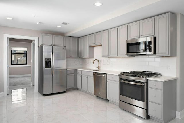 50 W Broad St Unit 2104, Columbus, OH 43215 - kitchen featuring baseboards, gray cabinetry, and stainless steel appliances