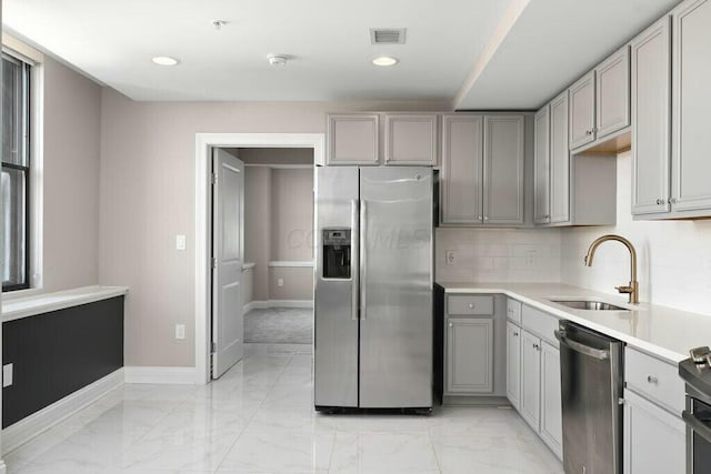 50 W Broad St Unit 2104, Columbus, OH 43215 - kitchen with a sink, marble finish floor, stainless steel appliances, gray cabinetry, and visible vents