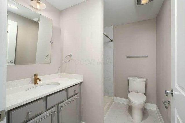 50 W Broad St Unit 2104, Columbus, OH 43215 - bathroom featuring marble finish floor, toilet, vanity, a walk in shower, and baseboards