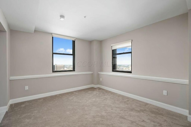 50 W Broad St Unit 2104, Columbus, OH 43215 - spare room with baseboards and carpet floors