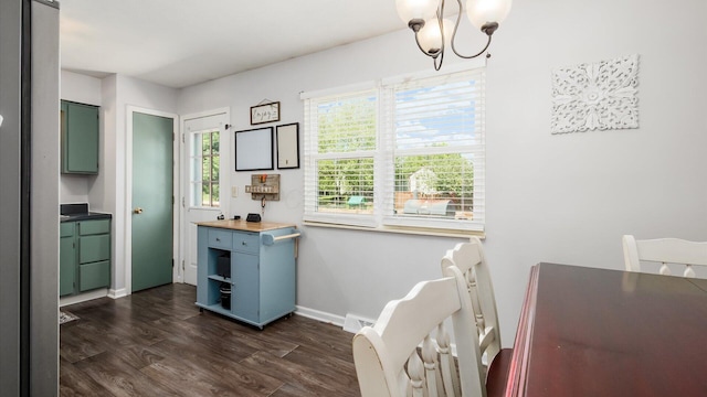 650 Licking View Dr, Heath, OH 43056 - dining area with a chandelier, dark wood finished floors, and baseboards