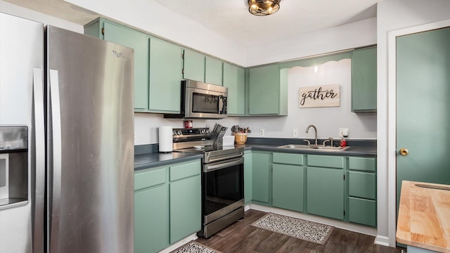 650 Licking View Dr, Heath, OH 43056 - kitchen featuring appliances with stainless steel finishes, a sink, dark wood-type flooring, and dark countertops