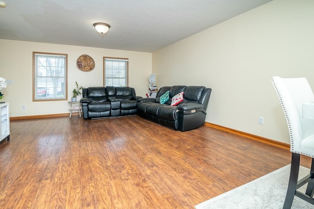 living area featuring baseboards and wood finished floors