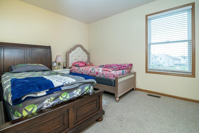 bedroom with light carpet, baseboards, and visible vents