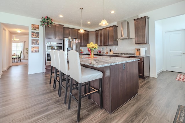 9295 Dewitt Dr, Plain City, OH 43064 - kitchen with dark brown cabinets, dark wood-style floors, wall chimney range hood, tasteful backsplash, and appliances with stainless steel finishes