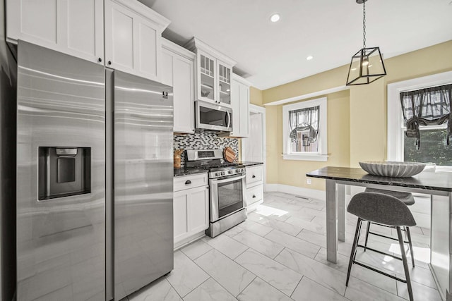 1812 Newark Granville Rd, Granville, OH 43023 - kitchen featuring stainless steel appliances, light marble finish floors, baseboards, tasteful backsplash, and white cabinets