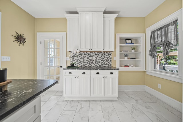 1812 Newark Granville Rd, Granville, OH 43023 - kitchen featuring light marble finish floors, plenty of natural light, decorative backsplash, and white cabinets