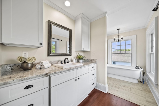 1812 Newark Granville Rd, Granville, OH 43023 - kitchen featuring a sink, baseboards, ornamental molding, dark wood-style floors, and a chandelier
