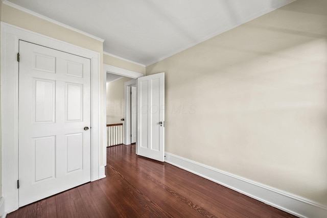1812 Newark Granville Rd, Granville, OH 43023 - unfurnished bedroom with dark wood-style flooring, crown molding, and baseboards