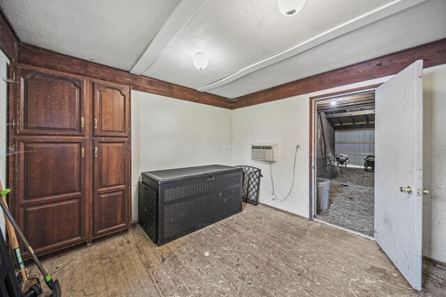 1812 Newark Granville Rd, Granville, OH 43023 - interior space featuring a wall mounted air conditioner, light wood-style floors, and a textured ceiling