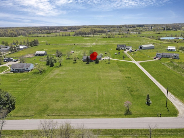 birds eye view of property with a rural view