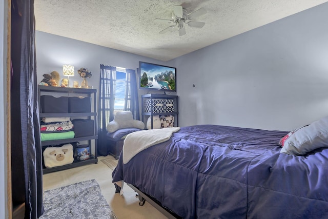 bedroom featuring a ceiling fan and a textured ceiling