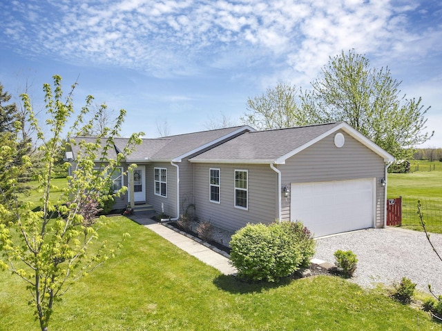 ranch-style home with roof with shingles, a front yard, fence, gravel driveway, and an attached garage