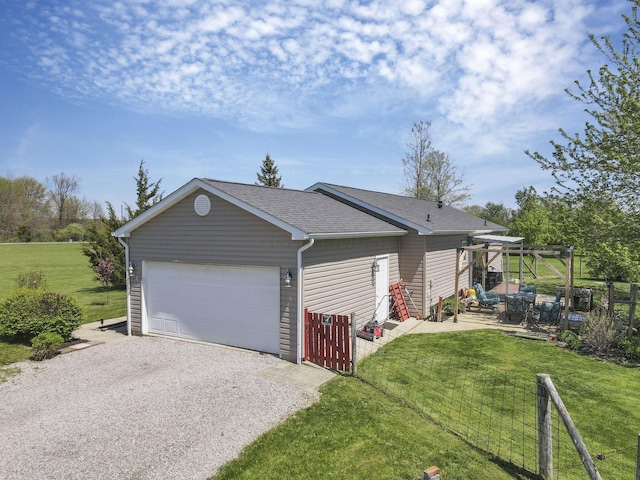 garage with fence and driveway
