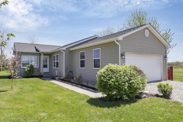 ranch-style home featuring a garage, a shingled roof, driveway, and a front yard