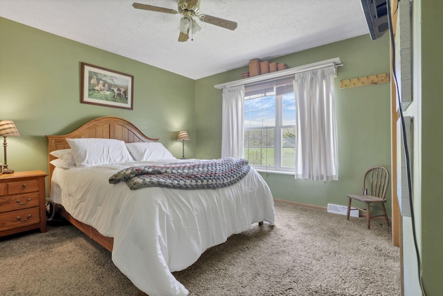 carpeted bedroom with baseboards, a ceiling fan, a textured ceiling, and visible vents