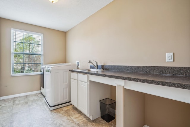 2128 Clay Stone Pl, Reynoldsburg, OH 43068 - laundry area with washer and dryer, baseboards, cabinet space, and a sink