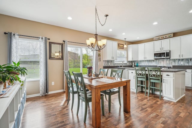 2128 Clay Stone Pl, Reynoldsburg, OH 43068 - dining area with an inviting chandelier, recessed lighting, dark wood-style floors, and baseboards