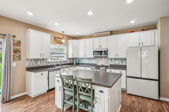 2128 Clay Stone Pl, Reynoldsburg, OH 43068 - kitchen with appliances with stainless steel finishes, dark countertops, decorative backsplash, and white cabinets